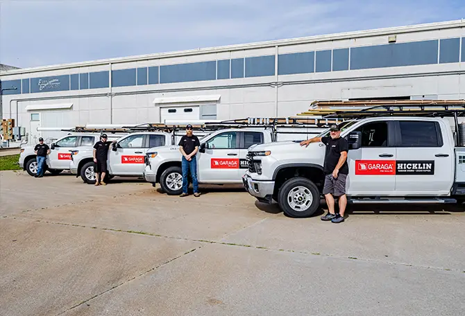 Employees of Hicklin Garage Door Services Cedar Rapids standing in front of their service truck.