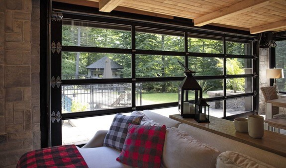A picture from inside the living room of a Scandinavian house of a full-view California garage door