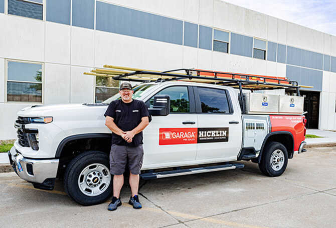 Garage door installer in front of his truck